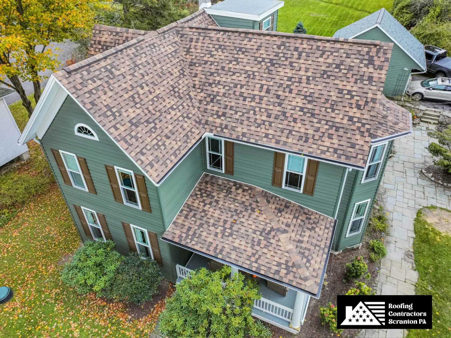 Classic home with a multi-colored asphalt shingle roof installation.